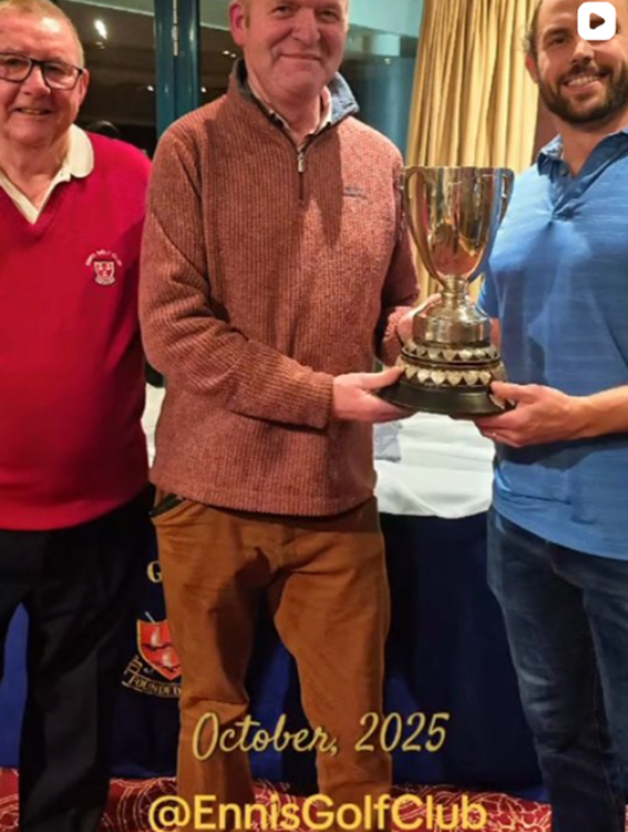 Three men celebrating with a trophy at Ennis Golf Club event, October 2025.