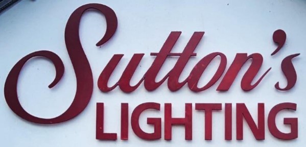 Sutton's Lighting store sign in elegant red script, showcasing decorative and modern lighting solutions.